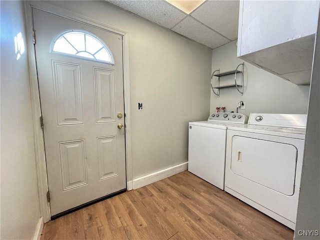 laundry area featuring separate washer and dryer and light hardwood / wood-style flooring