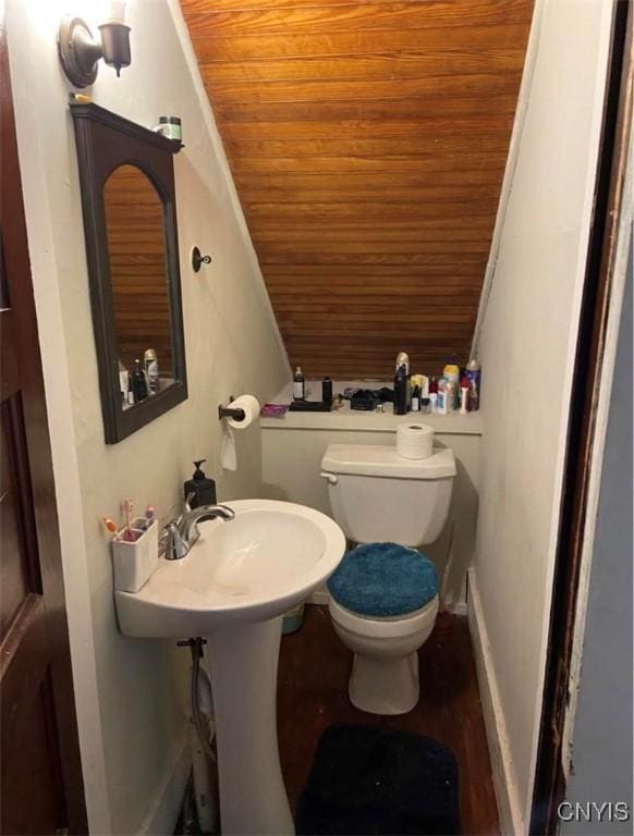 bathroom with toilet and wooden ceiling