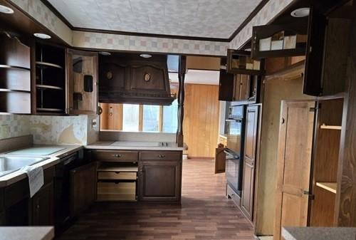 kitchen featuring double wall oven, dark hardwood / wood-style flooring, dark brown cabinetry, and crown molding