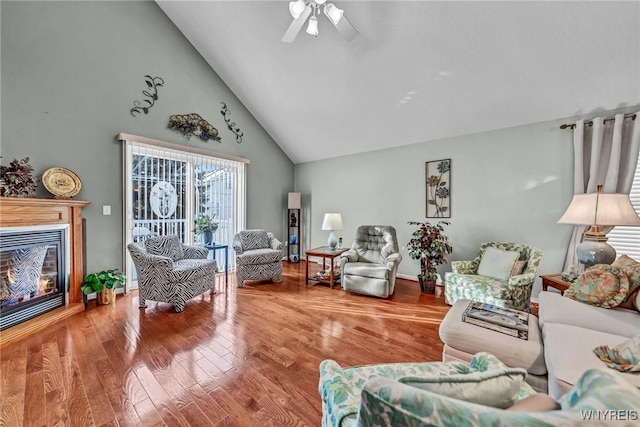 living room featuring hardwood / wood-style flooring, high vaulted ceiling, and ceiling fan