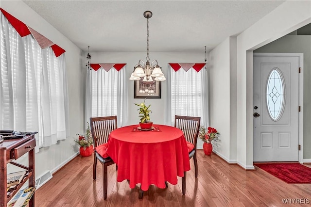 dining area featuring a chandelier and hardwood / wood-style flooring