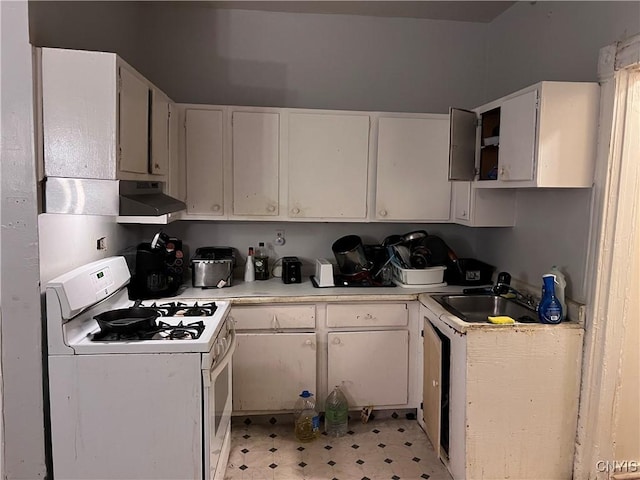 kitchen with white cabinetry, sink, and white gas range oven