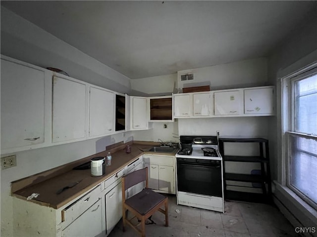 kitchen with white range with gas stovetop, white cabinetry, and sink