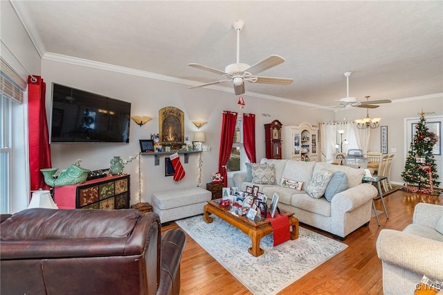 living room featuring crown molding, ceiling fan, and hardwood / wood-style flooring