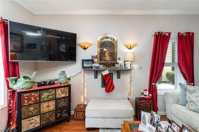 living area with wood-type flooring, ornamental molding, and a wealth of natural light