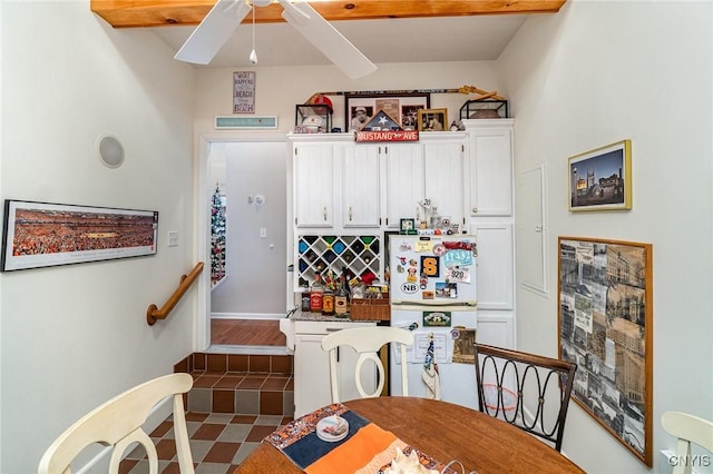 bar featuring white cabinets, ceiling fan, white fridge, and beamed ceiling