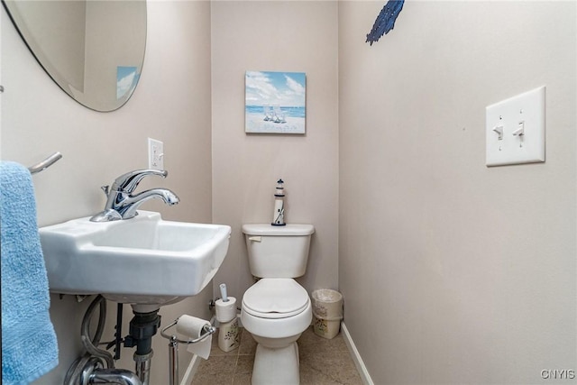 bathroom with tile patterned floors, toilet, and sink