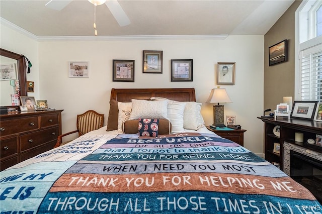 bedroom with ceiling fan and ornamental molding