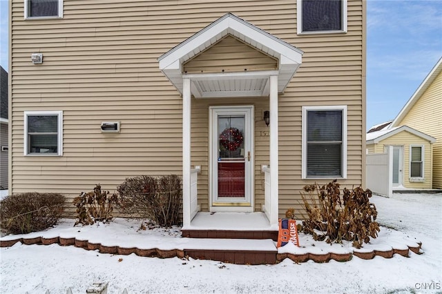 view of snow covered property entrance