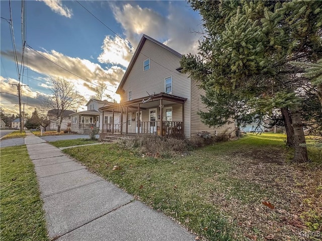 view of front of property featuring a lawn and a porch