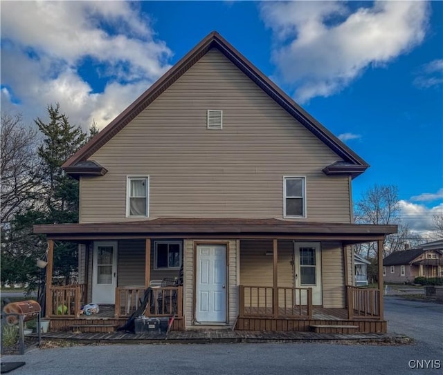 back of property with a porch