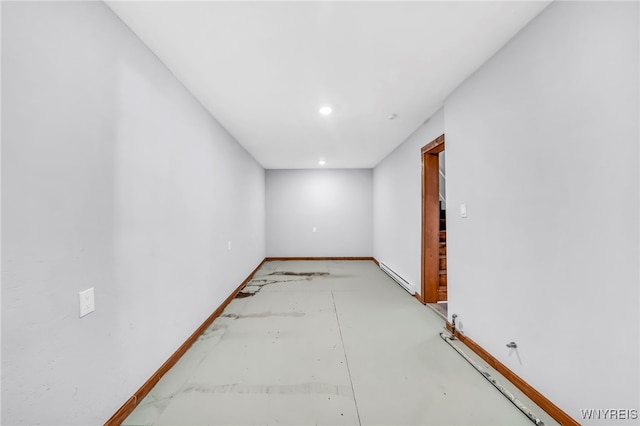 empty room featuring a baseboard heating unit