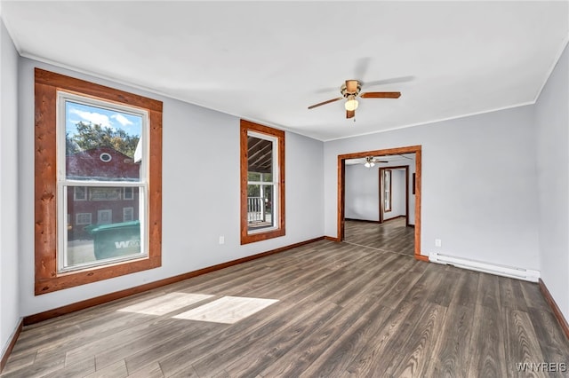 unfurnished room with ceiling fan, dark hardwood / wood-style flooring, and a baseboard heating unit