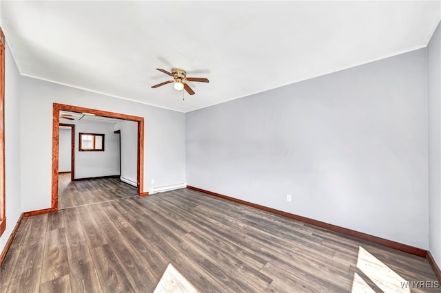 empty room with ceiling fan, dark wood-type flooring, and a baseboard heating unit