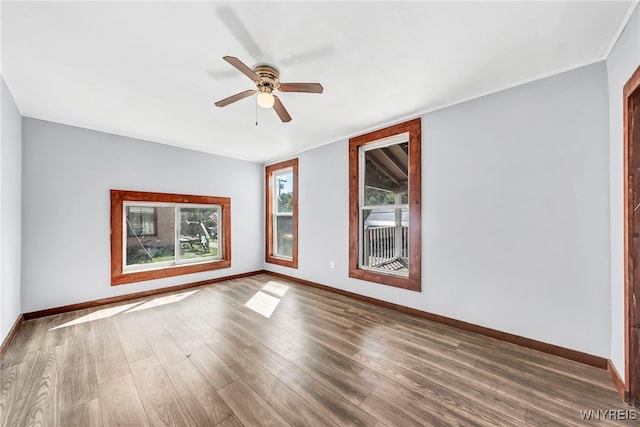 unfurnished room with ceiling fan and dark wood-type flooring