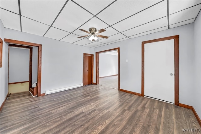 interior space featuring ceiling fan, dark wood-type flooring, a baseboard radiator, and a drop ceiling