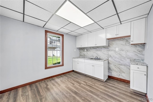 kitchen featuring light hardwood / wood-style flooring, white cabinets, and sink