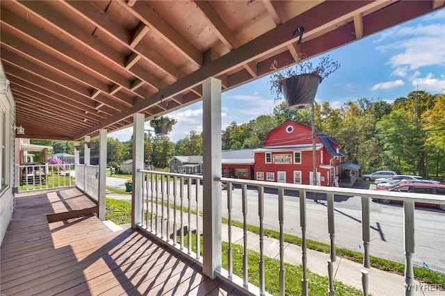 wooden terrace featuring covered porch