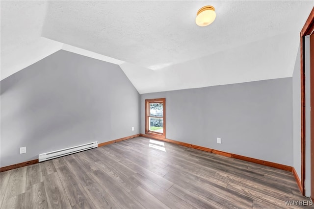 bonus room featuring a textured ceiling, a baseboard radiator, vaulted ceiling, and hardwood / wood-style flooring