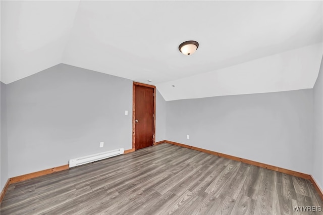 bonus room featuring hardwood / wood-style floors, baseboard heating, and lofted ceiling