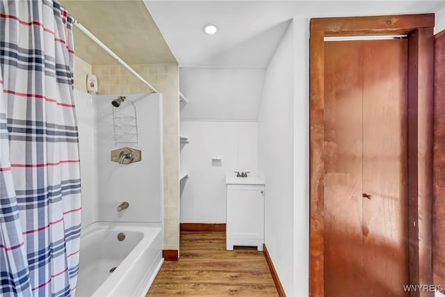 bathroom featuring vaulted ceiling, sink, shower / tub combo, and hardwood / wood-style flooring