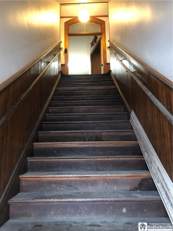 stairway with wood walls