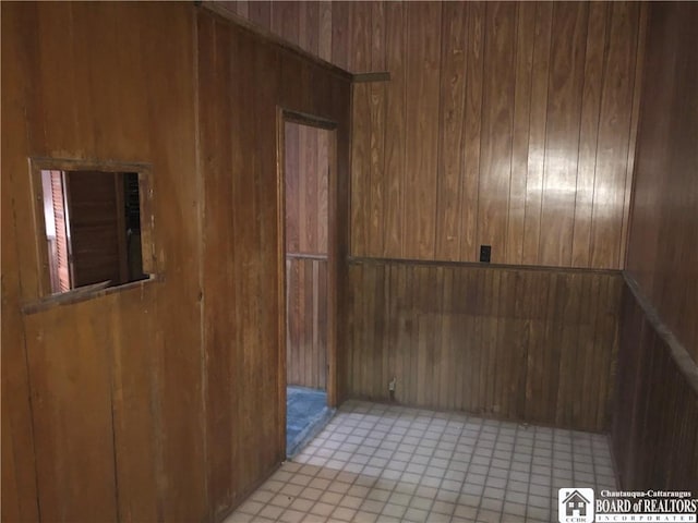 spare room with wood walls