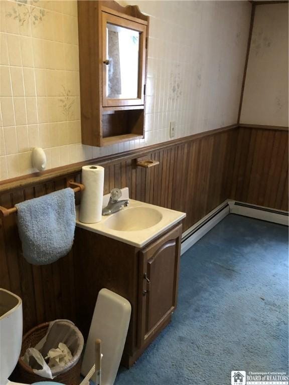 bathroom featuring vanity and wood walls