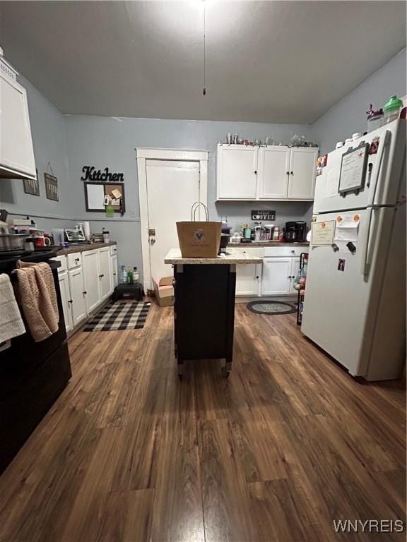 kitchen featuring white cabinets, white refrigerator, and dark wood-type flooring