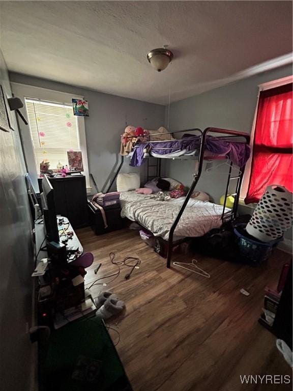 bedroom with hardwood / wood-style flooring