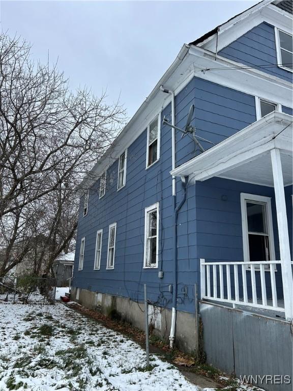 view of snowy exterior with a porch