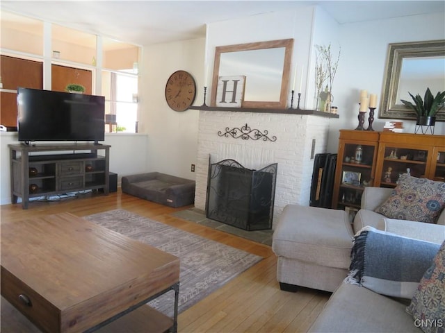 living room with a fireplace and hardwood / wood-style flooring