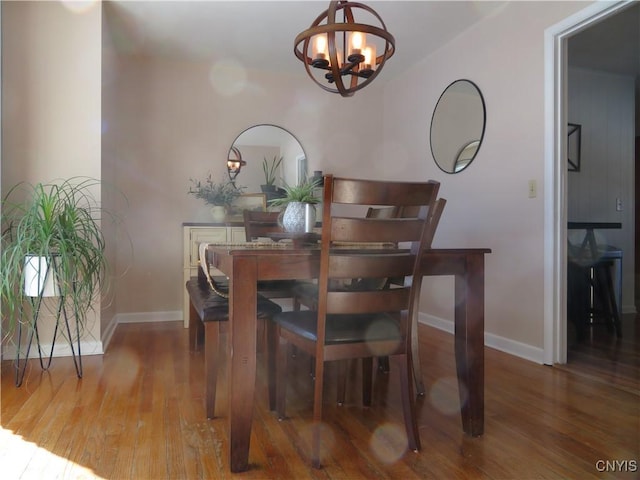 dining room featuring hardwood / wood-style floors and a notable chandelier