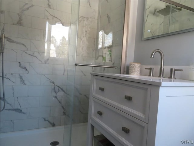 bathroom featuring vanity and a shower with shower door