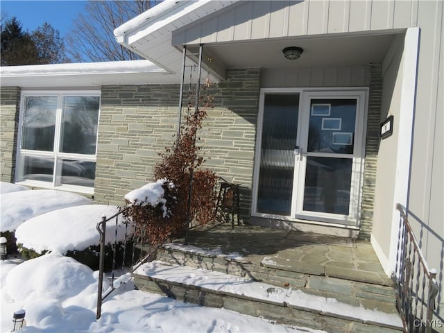 view of snow covered property entrance