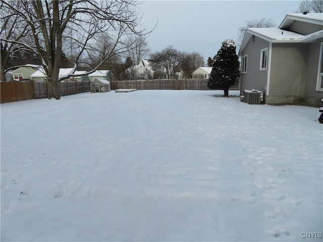 yard covered in snow with central AC