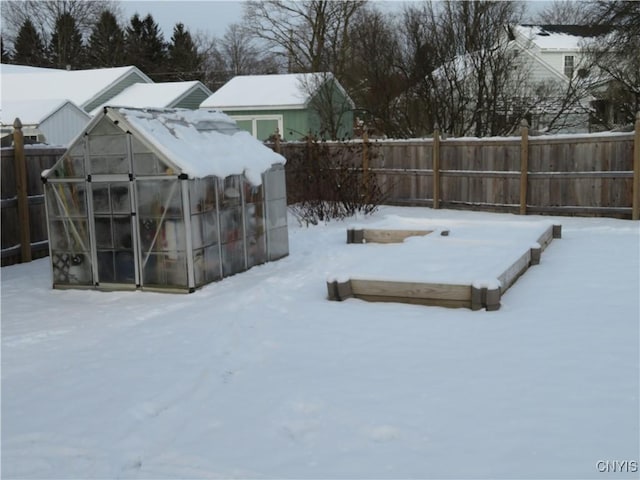 yard covered in snow with an outbuilding