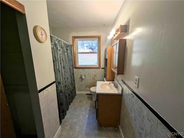 7909 County Route 333, Thurston, NY 14821 - bathroom with tile walls, toilet, wainscoting, a shower with shower curtain, and vanity