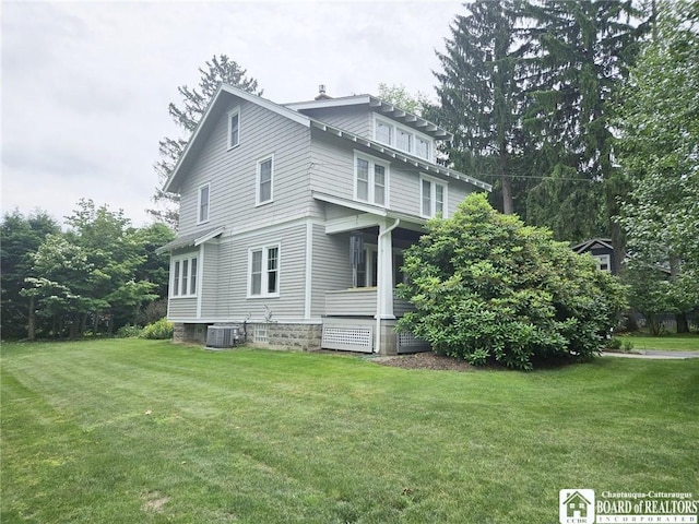 view of home's exterior featuring a yard and central air condition unit