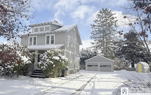 view of front of property featuring an outdoor structure and a garage