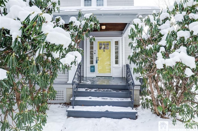 view of snow covered property entrance