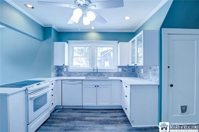 kitchen featuring white appliances, white cabinets, sink, ceiling fan, and dark hardwood / wood-style flooring