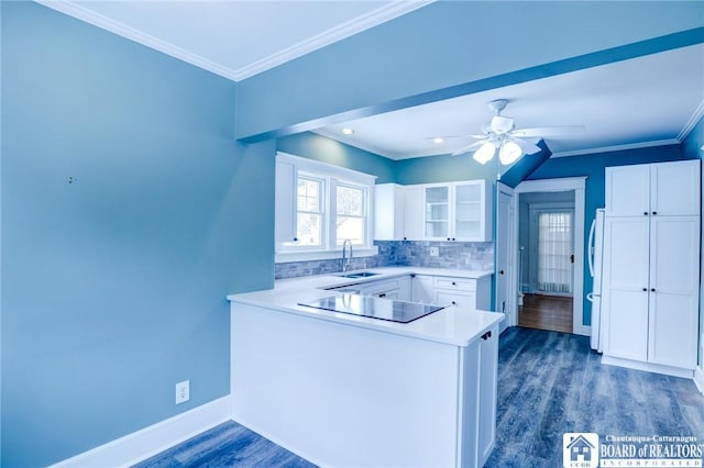 kitchen featuring backsplash, white cabinets, ceiling fan, black electric cooktop, and kitchen peninsula