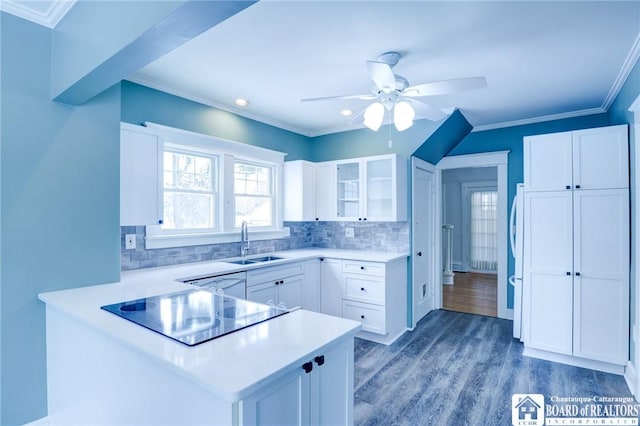 kitchen featuring white cabinets, kitchen peninsula, black electric cooktop, and sink