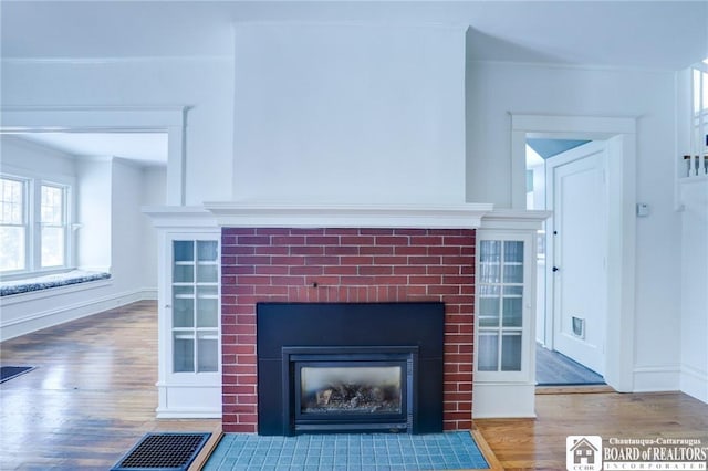 details featuring hardwood / wood-style flooring and crown molding