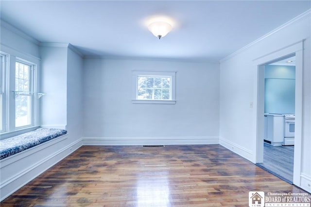 spare room with dark hardwood / wood-style floors and crown molding