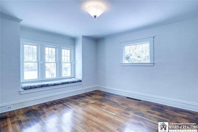 unfurnished room with a wealth of natural light, dark hardwood / wood-style flooring, and crown molding