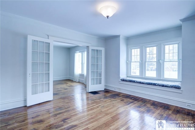 unfurnished room with a healthy amount of sunlight, wood-type flooring, and french doors