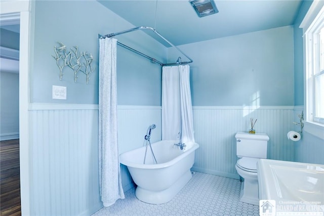 bathroom with shower / tub combo and toilet