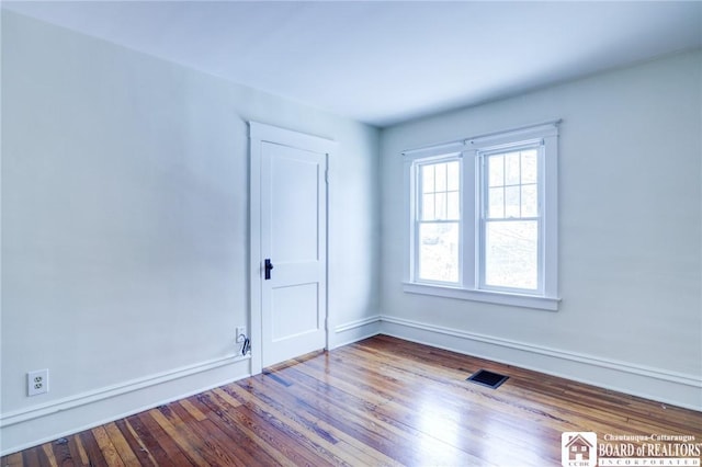 spare room featuring hardwood / wood-style floors